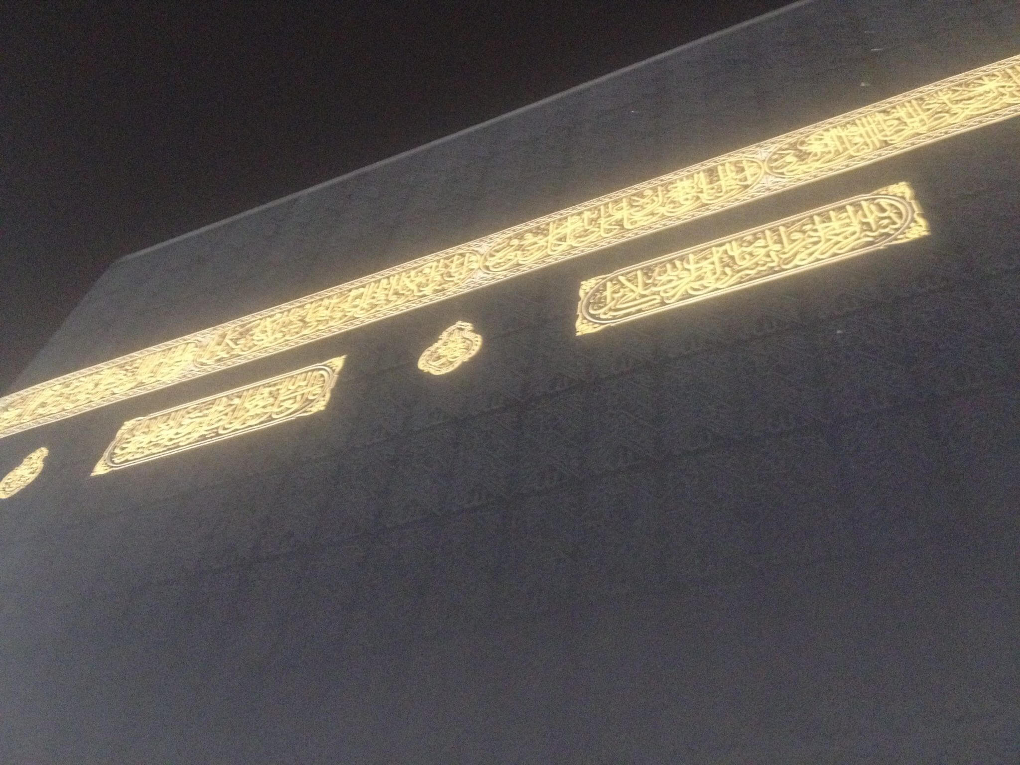 One side of the Holy Kaba with black cloth and gold banners